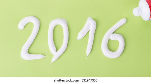 Tooth Paste In The Form Of Numbers 2016 On The Green Paper Background. Christmas Theme.