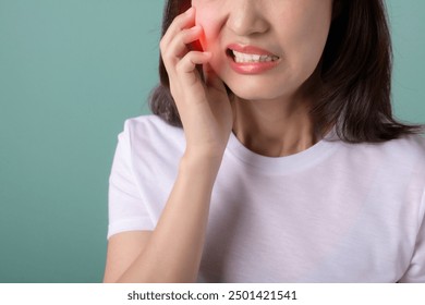 toothache jaw pain. asian young woman touching her mouth, expression, suffering from toothache, decay or sensitivity cavity molar tooth. toothache girl isolated on green background.. - Powered by Shutterstock