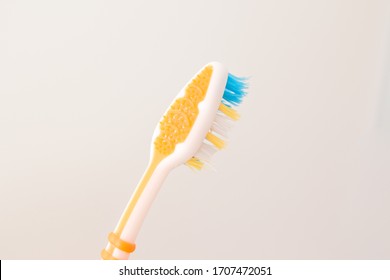 Toothbrush for cleaning the tongue close-up on a white background