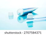 Toothbrush ready for use with toothpaste and cap on reflective surface during morning routine