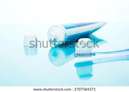 Toothbrush ready for use with toothpaste and cap on reflective surface during morning routine