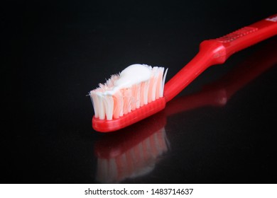 toothbrush and toothpaste isolated black background