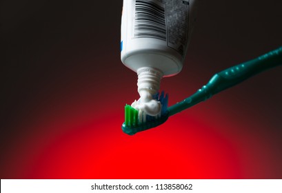 Toothbrush and toothpaste on red