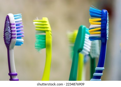 Toothbrushes in glass on table. Selective focus. - Shutterstock ID 2234876909
