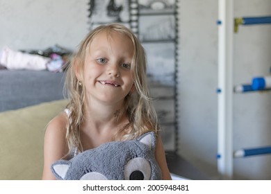 A Toothless Preschool Girl, Blonde, 6 Years Old, Smiling, She Has No Upper Teeth In Her Mouth.