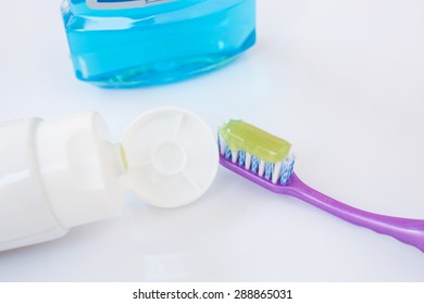 Toothpaste on toothbrush on white background.