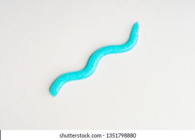 Toothpaste Snake On White Background. Personal Dental Hygiene Concept