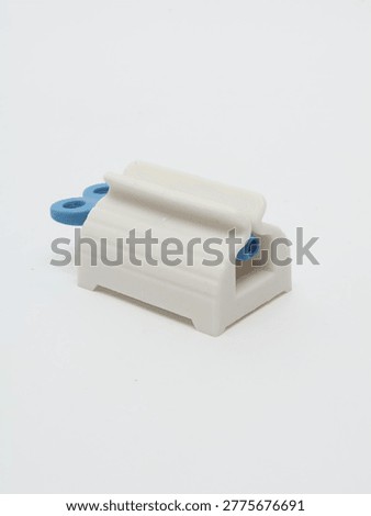 Toothpaste Squeezer on a gray background
