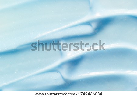 Toothpaste texture. Blue color abrasive dental paste smudged close up