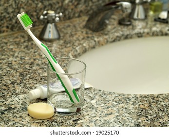 Toothpaste, Toothbrush And Soap On Bathroom Worktop