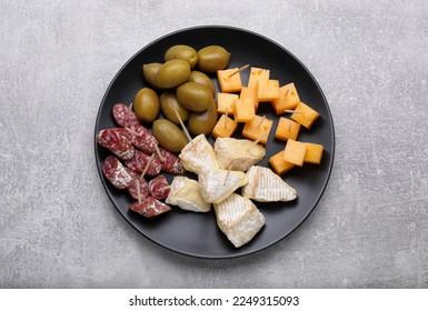 Toothpick appetizers. Pieces of cheese, sausage and olives on light grey table, top view
