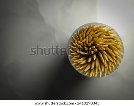 Toothpick made of wood on a gray background