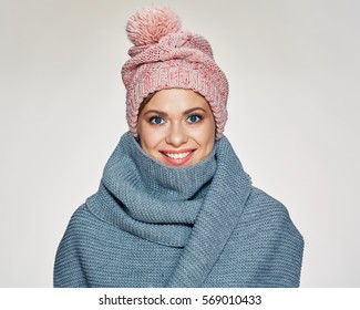 Toothy smiling woman portrait wearing winter scarf and hat. studio isolated .