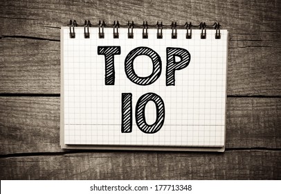 Top 10 written on paper sheet on wooden background