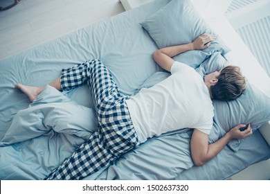 Top Above Back Side Photo Of Tired Man Feel Exhausted Lying On Bed Sleep Abdomen Belly Have Weekends In House Indoors Wear Plaid Checkered Pajama