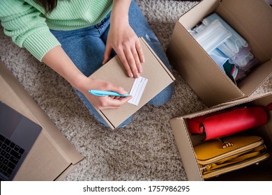 Top above high angle cropped close-up view of her she girl sale manager freelancer sitting on carpet packing order thing accessory distribution industry self-employed writing address home-based office