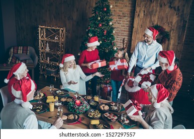 Top Above High Angle Photo Of Big Large Family With Small Little Kids Mature Sit Around Table X-mas Meal Man Hold Red Sack Back Give Gift Box Wish Dream In House With Christmas Tree Follow Tradition