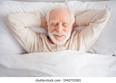 Top above high angle photo of aged man sleep rest relax bedtime comfort cozy happy positive wear pajamas hands behind head home - Powered by Shutterstock