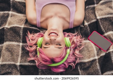 Top above high angle photo of young cheerful girl happy positive smile lying blanket listen music headphones outdoors - Powered by Shutterstock