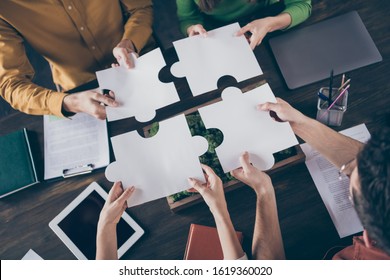 Top Above High Angle View Photo Of Focused Freelancer People Sit Table Desk Merge Paper Puzzle Pieces Elements Trust Support Company Career Coaching Concept In Workstation Workplace