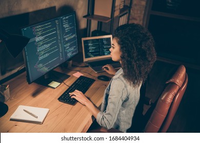 Top above high angle view photo of concentrated afro american girl sit evening table desk work server framework website maintenance operating system html document use pc in workstation - Powered by Shutterstock