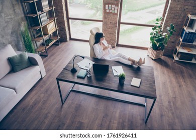 Top above high angle view of chic elegant lady insurance specialist drinking beverage put legs on desk at modern industrial loft brick wooden interior workplace workstation open space