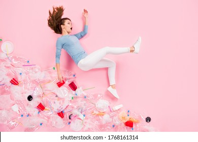 Top above high angle view full size profile side photo of crazy girl fall down hill trash plastic cup glass plate bags wear jumper pants flat lay isolated pastel color background