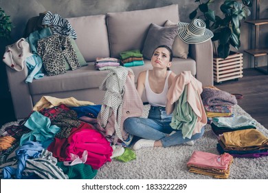 Top above high angle view photo of frustrated girl prepare for boyfriend date hold sweater shirt have problem what wear sigh sit floor carpet legs crossed folded in house indoors