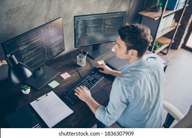 Top above high angle view portrait of his he nice attractive focused skilled geek guy typing bug track report cyberspace security at modern industrial interior style concrete wall work place station - Shutterstock ID 1836307909