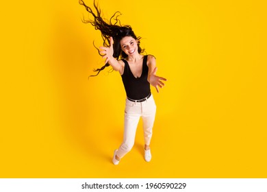 Top Above High Angle View Full Body Photo Of Young Excited Girl Fly Air Hair Happy Smile Isolated Over Yellow Color Background