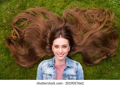 Top above high angle view photo of young cheerful girl happy positive smile lying grass haircare enjoy rest relax outdoors - Powered by Shutterstock