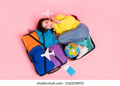 Top Above High Angle View Photo Of Young Excited Girl Ready For Trip Abroad Low-cost Isolated Over Pink Color Background