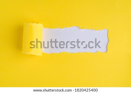 Top above overhead view photo of torn yellow paper over white background with copyspace