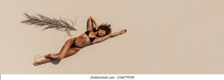 Top Aerial Drone View Of Woman In Swimsuit Bikini Relaxing And Sunbathing On Beach