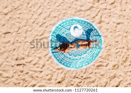 Top Aerial Drone View Of Woman In Swimsuit Bikini Relaxing And Sunbathing On Round Turquoise Beach Towel Near The Ocean