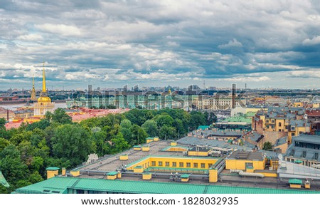 Top aerial panoramic view of Saint Petersburg Leningrad city with Alexander Garden, State Hermitage Museum, Winter Palace, Neva river, golden spire of Admiralty building, dramatic sky, Russia