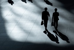 Top Aerial View Of Back Two Businessmen Walk And Hold Briefcase In Work Time At Pedestrian. With Lighting And Shadow.
