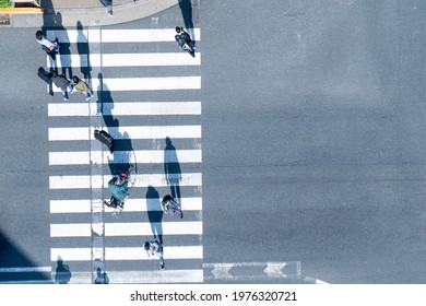 Top Aerial View Of Blur Men And Women People In Winter Cloth And Business Dress Walk Across Crosswalk In Street. Concept Normal Life Of Massive People With Transportation And Signage On The City Road.