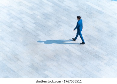 top aerial view businessman people walk on across pedestrian concrete with black silhouette shadow on ground, concept of social still life. - Powered by Shutterstock