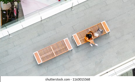 Top Aerial View Fashion Woman With Shopping Bag Uses Smartphone Sit On Wooden Bench At Walkway Pedestrian With Blur People Are Walking, , Concept Of Social Still Life With Technology And Lifestyle