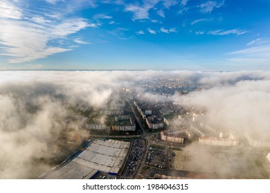 Top aerial view of fluffy white clouds over modern city with high rise buildings. - Powered by Shutterstock