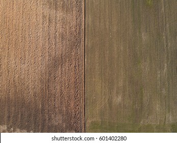 Top Aerial View Of Furrows Row Pattern In A Plowed Field Prepared For Planting Crops In Spring. Growing Wheat Crop In Springtime. Aerial View Of Harvest Fields In Lithuania