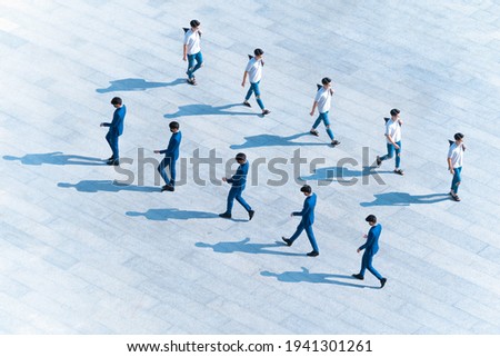 top aerial view man people with face mask walk on pedestrian concrete with silhouette shadow, concept of social new normal life of pattern one man walking. Post production one man in many position.
