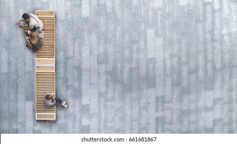 Top Aerial View Of People Sit On Wood Bench At The Upper Floor Pedestrian.