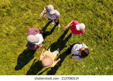 Top Aerial View Of People Standing In Circle On Green Grass. Drone Photography