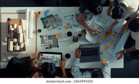 Top aerial view of project manager or civil engineer writing at blueprint and planning building design. Aerial view of architect working together at meeting table with document placed. Alimentation. - Powered by Shutterstock