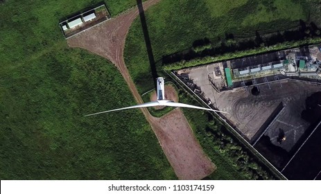 Top Aerial View Of Wind Turbine In Industrial Area, Green Energy.