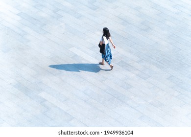 top aerial view woman people walk on across pedestrian concrete with black silhouette shadow on ground, concept of social still life.

 - Powered by Shutterstock