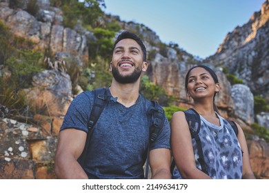 The Top Always Provides The Best Views. Shot Of A Young Couple Enjoying The Sunset View While Out On A Hike On A Mountain Range.