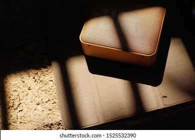 Top Angle Of Bluetooth Speaker With Shade Background And Shadow Effect